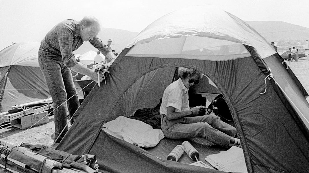 Image of President and First Lady Carter in their tent at a construction site in Mexico.